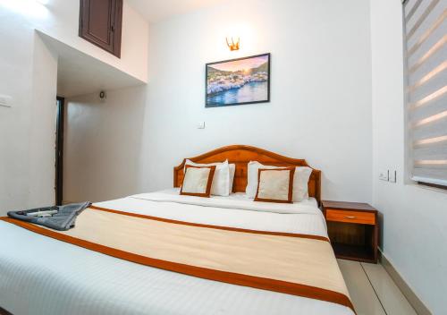 a bedroom with a large bed in a room at Pop Tavern Kovalam Beach Villa by VOYE HOMES in Kovalam