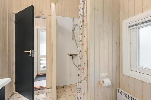a bathroom with a shower and a window at Summer House Close To Nature And Beach in Dronningmølle