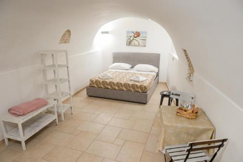 a bedroom with a bed and a ladder and a table at joy's home in Bari