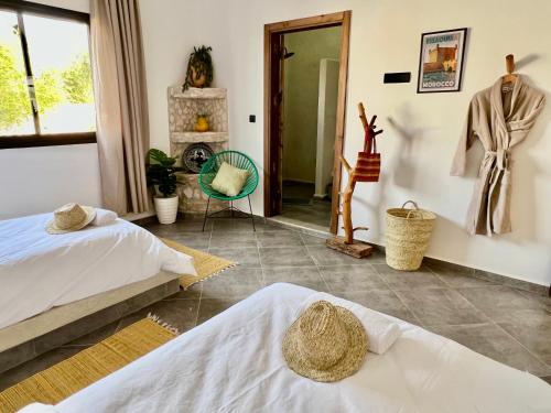 a bedroom with two beds and a fireplace at Villa Serinie in Essaouira