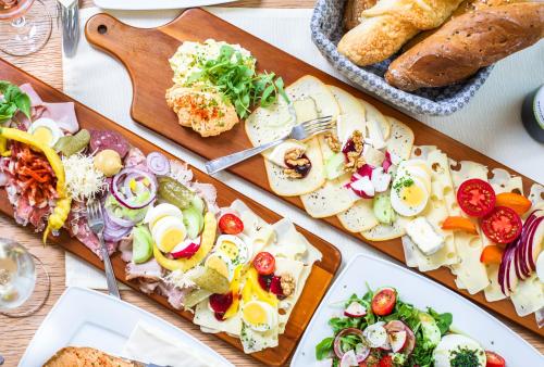 a table topped with plates of food and bread at Weingut Stadler in Falkenstein