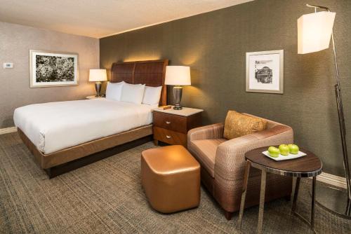 a hotel room with a bed and a chair at Hilton Washington DC/Rockville Hotel & Executive Meeting Center in Rockville
