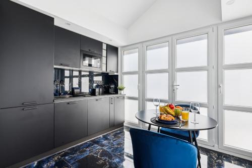 a kitchen with a table with a plate of fruit on it at Suite prestige avec jacuzzi in Pontault-Combault