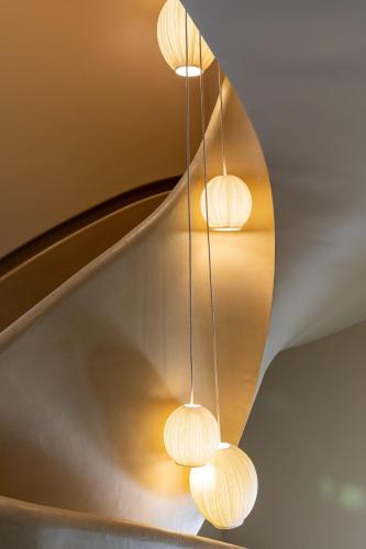 a group of lights hanging from a ceiling at Yndo Hôtel in Bordeaux