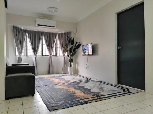 a living room with a large rug on the floor at Nur Homestay Permai Damansara Damai in Petaling Jaya