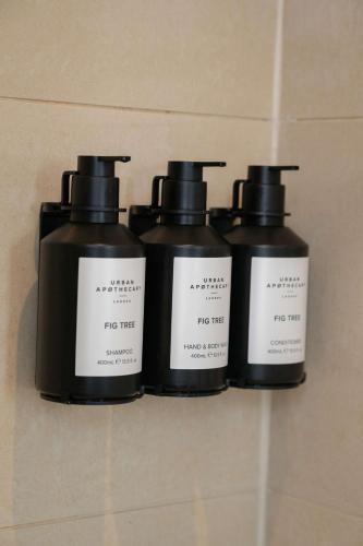 three bottles of fire mist on a wall at Radisson Blu Hotel, London Bond Street in London