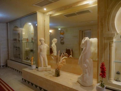 a bathroom with statues on a counter in front of a mirror at Welcome Meridiana in Djerba