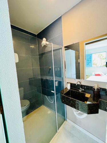 a bathroom with a sink and a toilet at CASA JASMIM, vila florescer, centro histórico!! in Piranhas