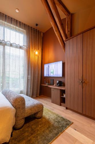 a bedroom with a bed and a large window at Yndo Hôtel in Bordeaux