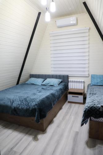 a bedroom with a large bed and a window at Aframezing Gabala in Gabala