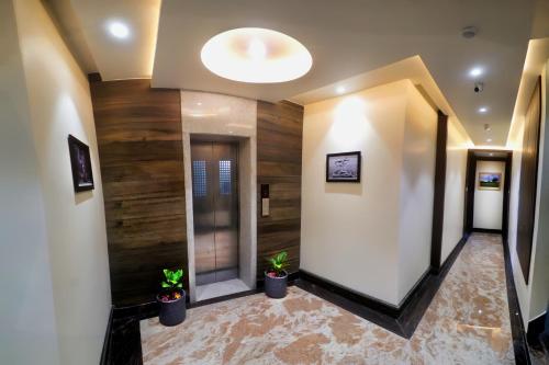 a hallway with wooden walls and potted plants at Coco Cabana in Varanasi