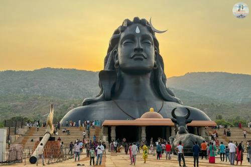 a crowd of people standing around a large statue at Villa Grand Hotel Near Kempegowda International Airport in Bengaluru