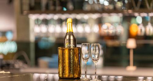 a bottle of champagne sitting next to two wine glasses at Aiden by Best Western Biberach in Biberach an der Riß