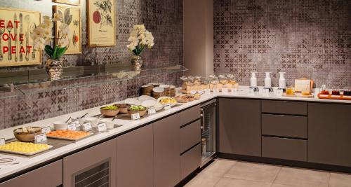 a buffet line with food on it in a restaurant at Aiden by Best Western Biberach in Biberach an der Riß