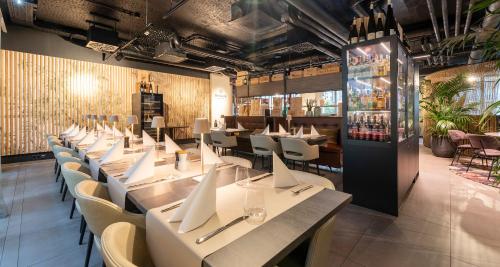 a row of tables and chairs in a restaurant at Aiden by Best Western Biberach in Biberach an der Riß