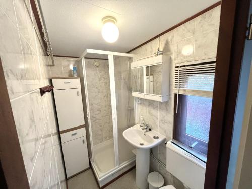 a small bathroom with a sink and a shower at Beach Resort Kamperland - 771 in Kamperland