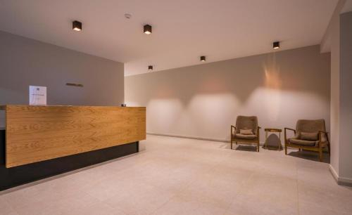 a waiting room with two chairs and a counter at Ski In/Out Apartment in New Gudauri, Loft 2 in Gudauri