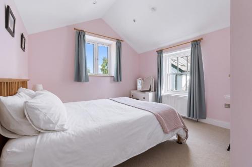 a bedroom with a white bed and a window at Quiet Devon Luxury Escape 3-Bed in Honiton
