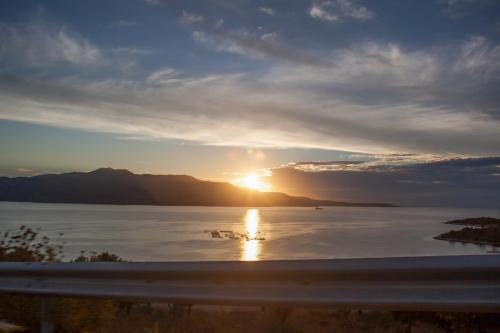 a sunset over a large body of water at Hotel Livia in Ksamil