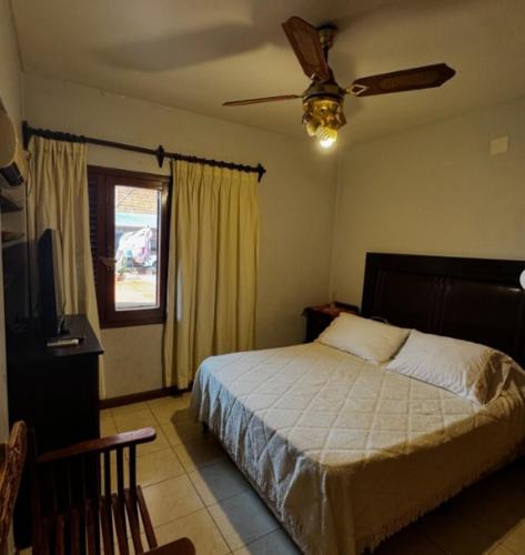 a bedroom with a bed and a ceiling fan at CASONA COMPLETA jn in Posadas