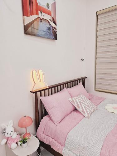 a bedroom with a bed with pink sheets and a table at 인천시청 길병원 인천터미널역 롯데백화점 앞 인기숙소 in Incheon
