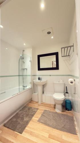 a bathroom with a toilet and a sink and a shower at Modern spacious Studio opposite station II in London