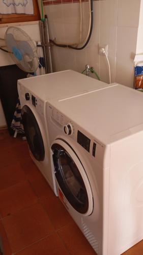 a white washing machine sitting in a room at All ombra del carrubo in Ottava Sassari
