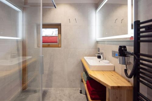 a bathroom with a sink and a shower at Chalet Tannenhaus II in Gmünd in Kärnten