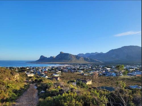 a view of a town with mountains in the background at C es Cape in Pringle Bay