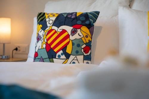 a pillow with a heart on a bed at Special PRIMERO PICASSO Apartment Basel, Bahnhof Grossbasel 10-STAR in Basel