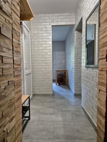 a hallway with a brick wall and a bench at Центр Проспект Центральный 184 АТБ in Mykolaiv