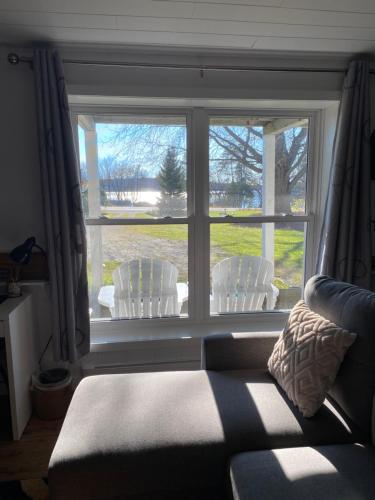 a living room with a window with chairs and a couch at Our Place Up North BnB in Huntsville