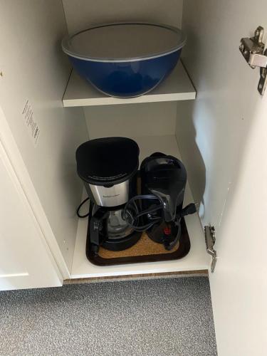 a coffee maker in a cabinet with a bowl at Our Place Up North BnB in Huntsville
