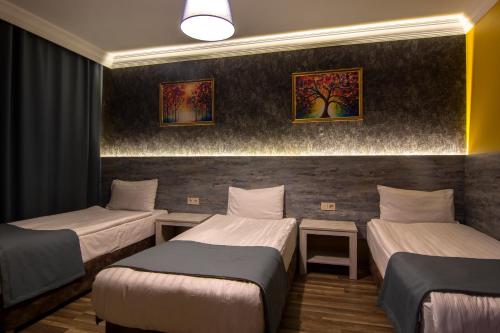 Postel nebo postele na pokoji v ubytování Baykara Hotel