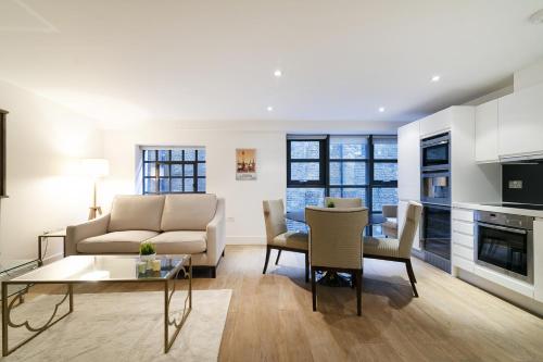 a living room with a couch and a table at Bull Inn Court - Walking distance to Covent Garden Square in London