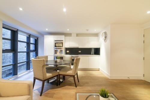 a kitchen and dining room with a table and chairs at Bull Inn Court - Walking distance to Covent Garden Square in London