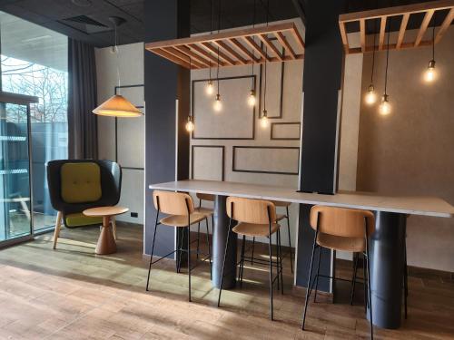 a kitchen with a large table and chairs at Campanile La Roche Sur Yon Centre Gare in La Roche-sur-Yon