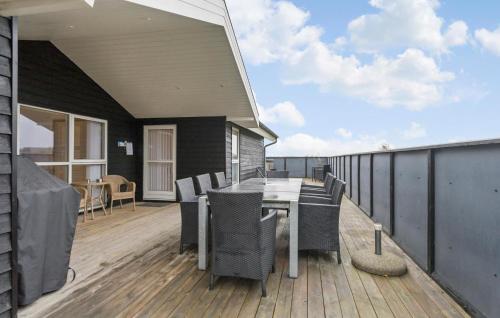 a patio with a table and chairs on a deck at Stunning Home In Strandby With Wifi in Strandby