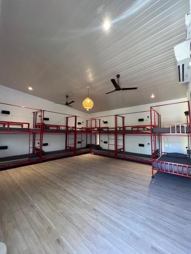 an empty room with two bunk beds in a gym at Whoopers Hostel Palolem in Palolem