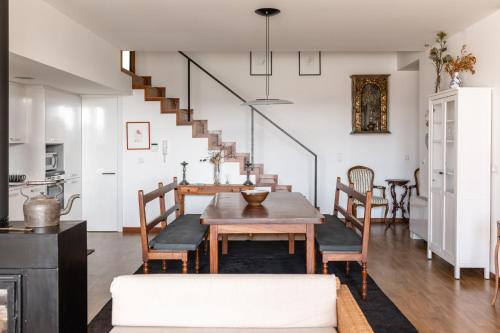 a dining room with a table and chairs and a staircase at Casa da Corujeira - Montalegre in Montalegre