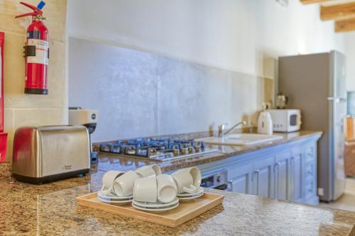 a kitchen with white shoes sitting on a counter at Villagg tal-Fanal in Għasri