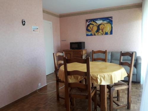 d'une table à manger avec des chaises et un tissu de table jaune. dans l'établissement Appartement avec terrasse - Calme et soleil - Proche de la plage, à Marseille