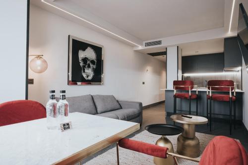 a living room with a couch and a table at Poem Suites by Airnest in Las Palmas de Gran Canaria