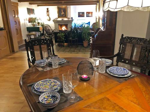 a table with blue and white plates and glasses on it at Großes Ferienhaus - Own cottage near Chiemsee in Bergen