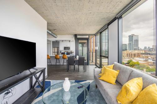 a living room with a couch and a tv at Freshly Minted 2BR - Elegance & Comfort in Central Chicago in Chicago