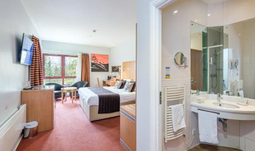a hotel room with a bed and a bathroom at High Range Lodge Hotel in Aviemore
