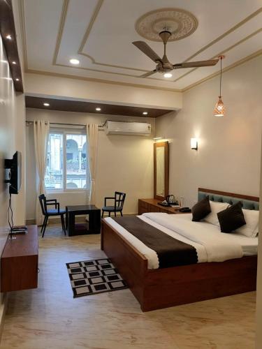 a bedroom with a large bed and a living room at Happy Home Paying Guest House in Varanasi