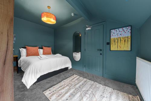 a bedroom with a bed and a blue wall at Boutique Home in Lake District, West Cumbria in Workington
