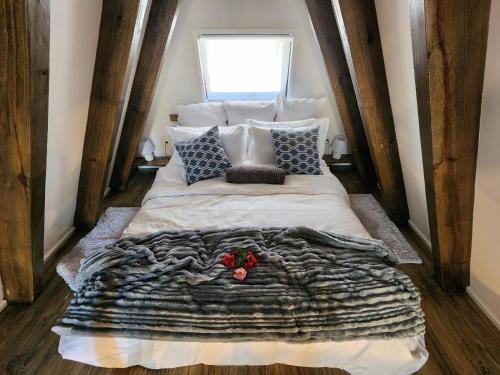 a bedroom with a large bed with a blanket and pillows at Treehaven Retreat in Hogsback