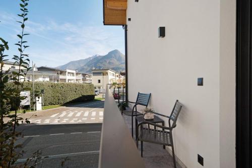 a balcony with two chairs and a table with a view at Apartment Fuchsberger in Lana